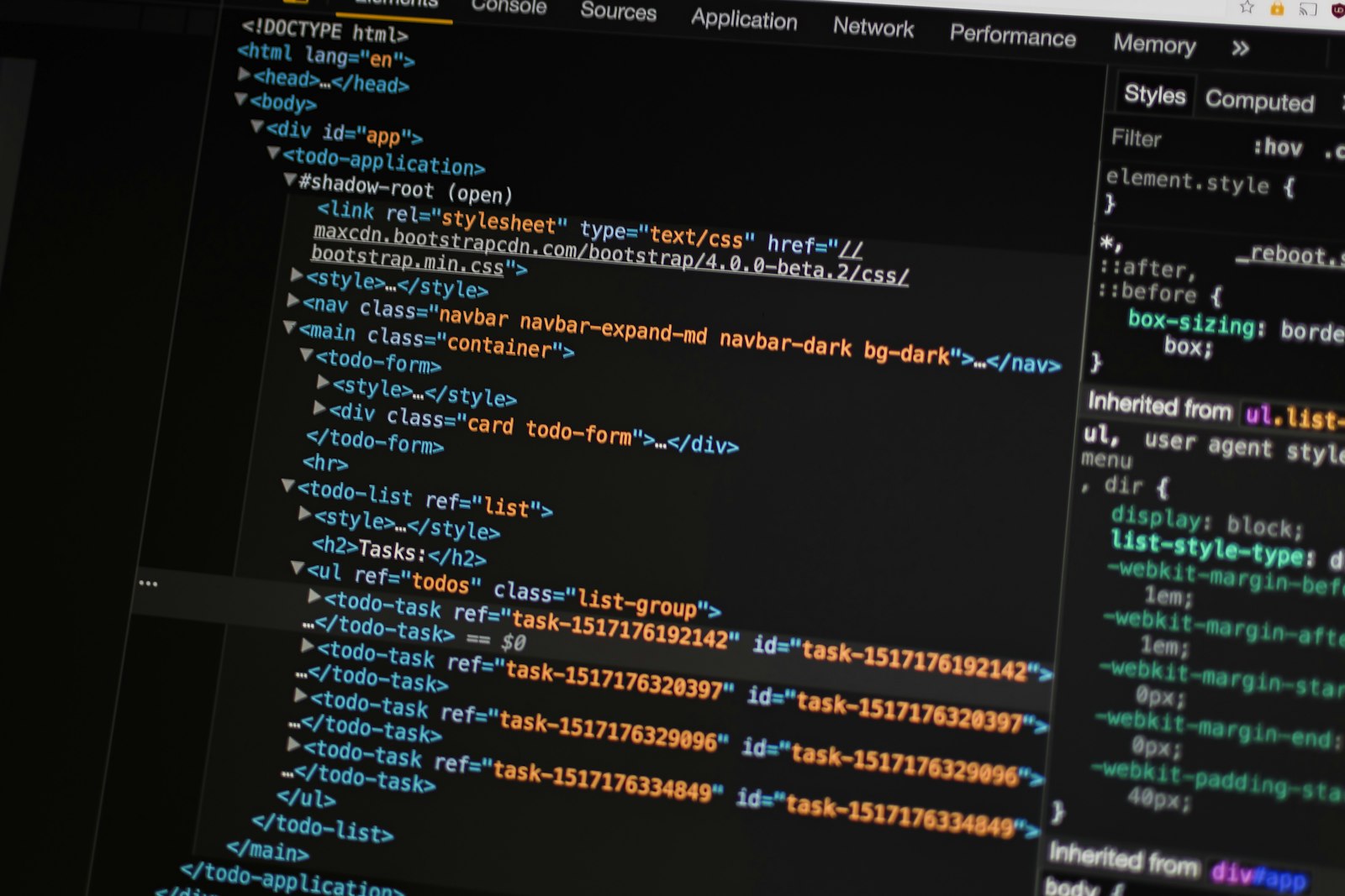 Software developer working on user interface code across multiple monitors